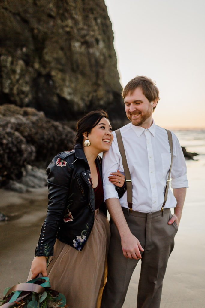 bride in embroidered leather jacket during styled elopement at cannon beach
