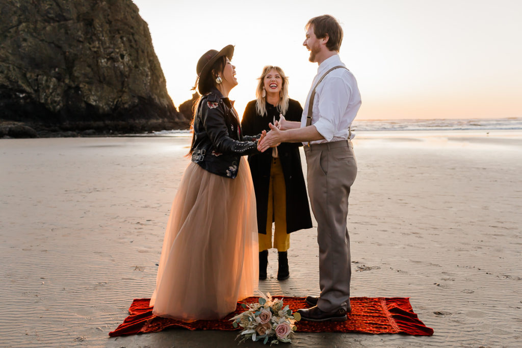 saying vows during styled elopement at cannon beach