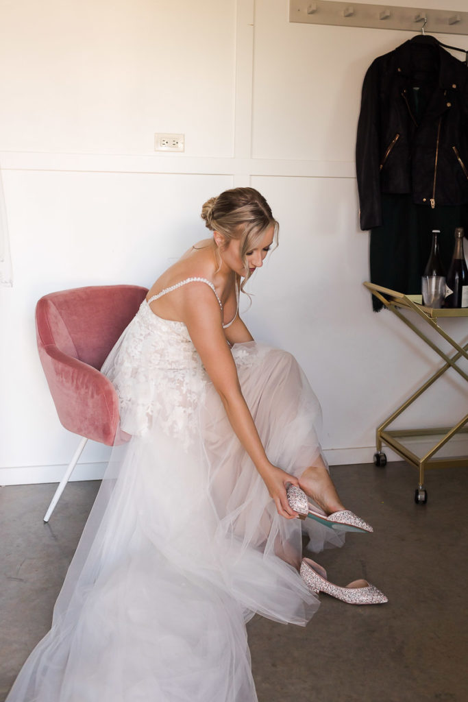 bride in tulle gown getting ready for first look
