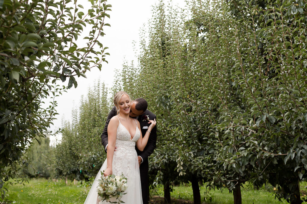 bride and groom during first look at the orchard in hood river