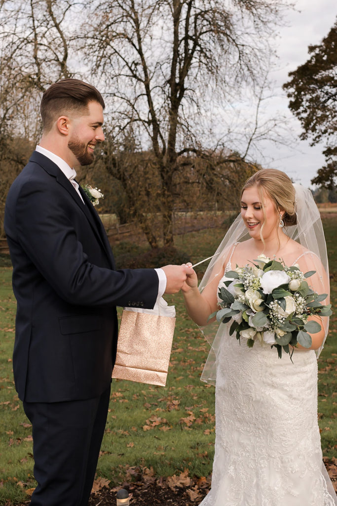 bride and groom exchanging gifts during first look