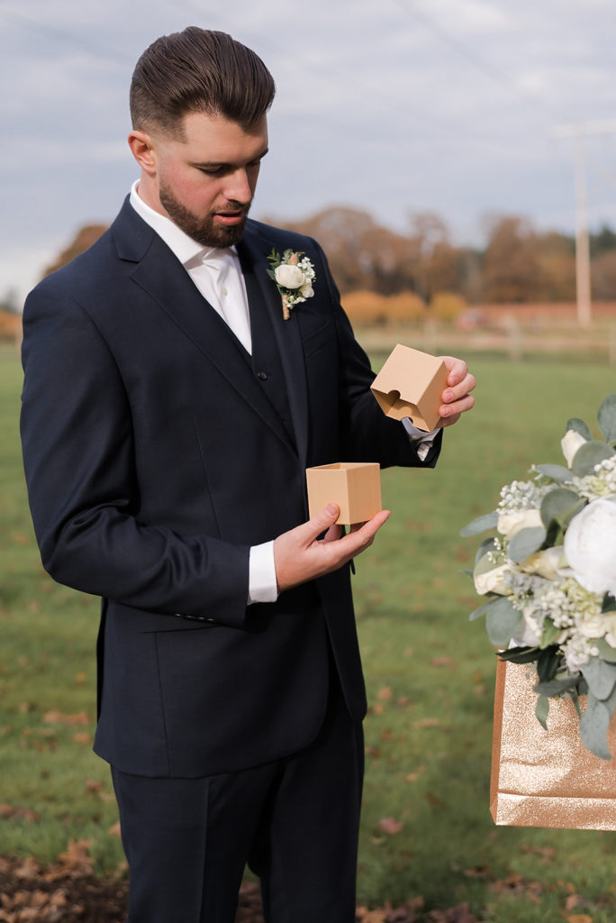 groom opening gift from bride