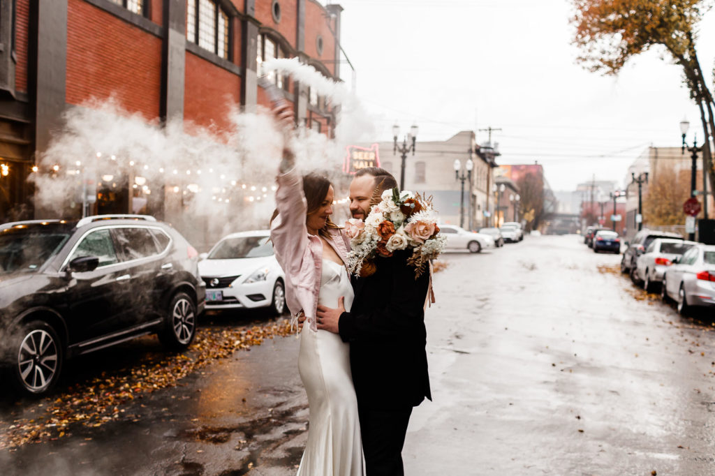 bride and groom having fun in the middle of street