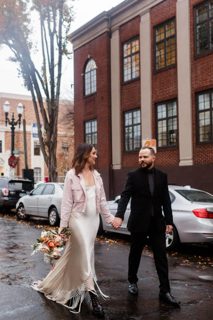 bride and groom walking in downtown portland