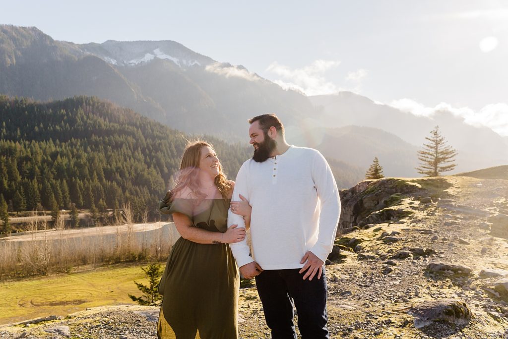Couple looking at each other out on Mountain range with clouds touching the mountain Government Cove Oregon Engagement Photography captured by Oregon Engagement Photographer Simply Wandering Photography 