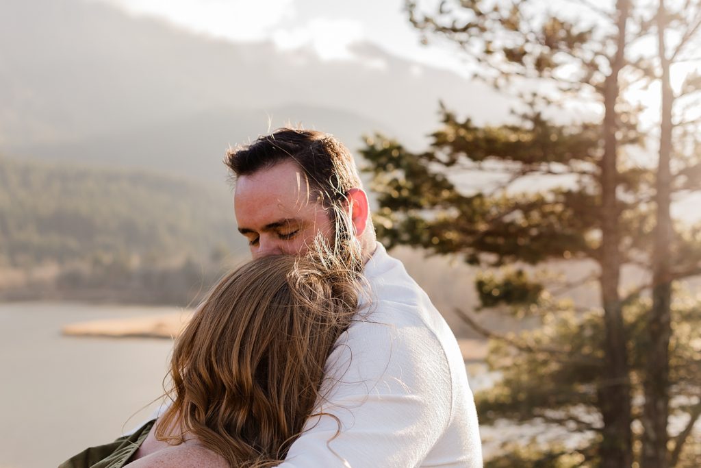 Couple holding each other by the lakeside Government Cove Oregon Engagement Photography captured by Oregon Engagement Photographer Simply Wandering Photography 