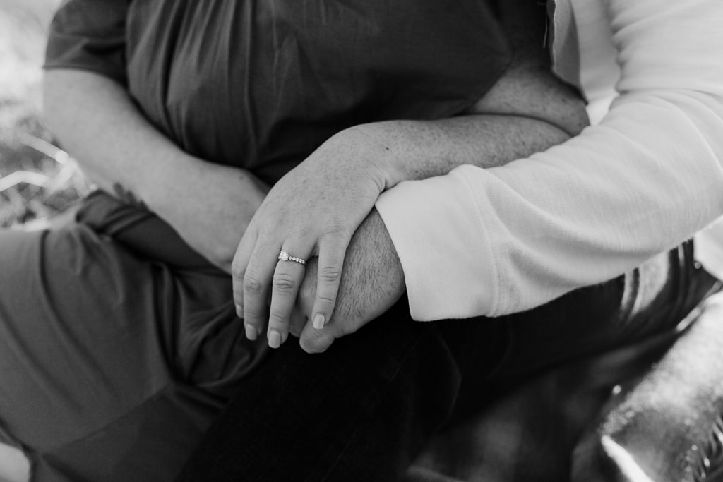B&W Closeup of Couple holding hands showing off engagement ring Government Cove Oregon Engagement Photography captured by Oregon Engagement Photographer Simply Wandering Photography 