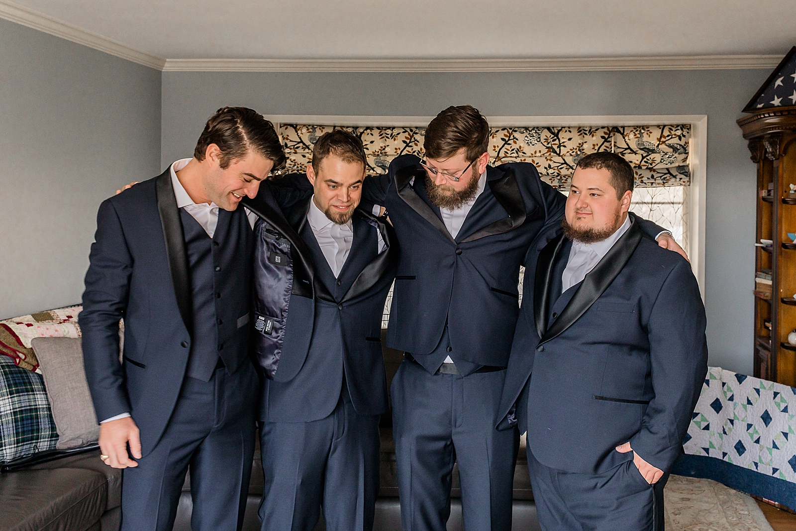 Groom and Groomsmen in jackets arms around each other ready 