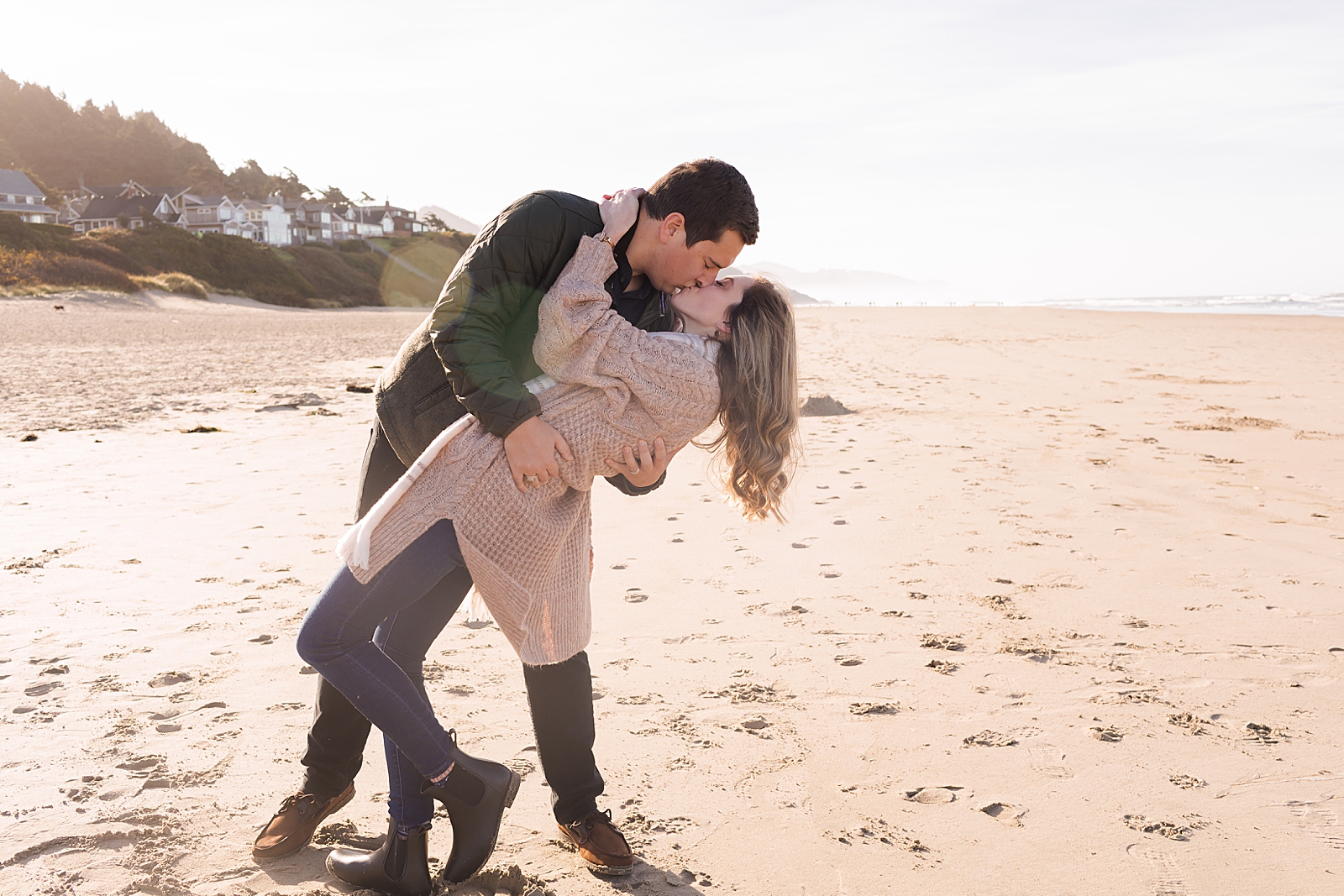 Couple dipping on the sand and kissing