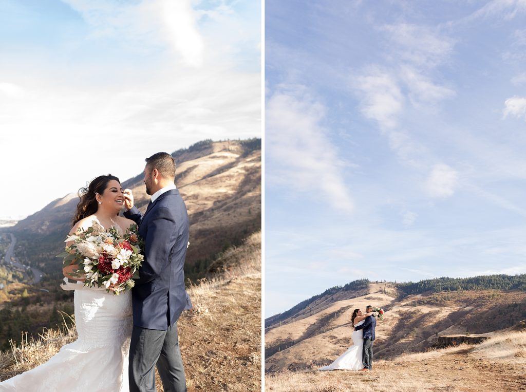 Groom moving hair out of Bride's face with the mountains behind them