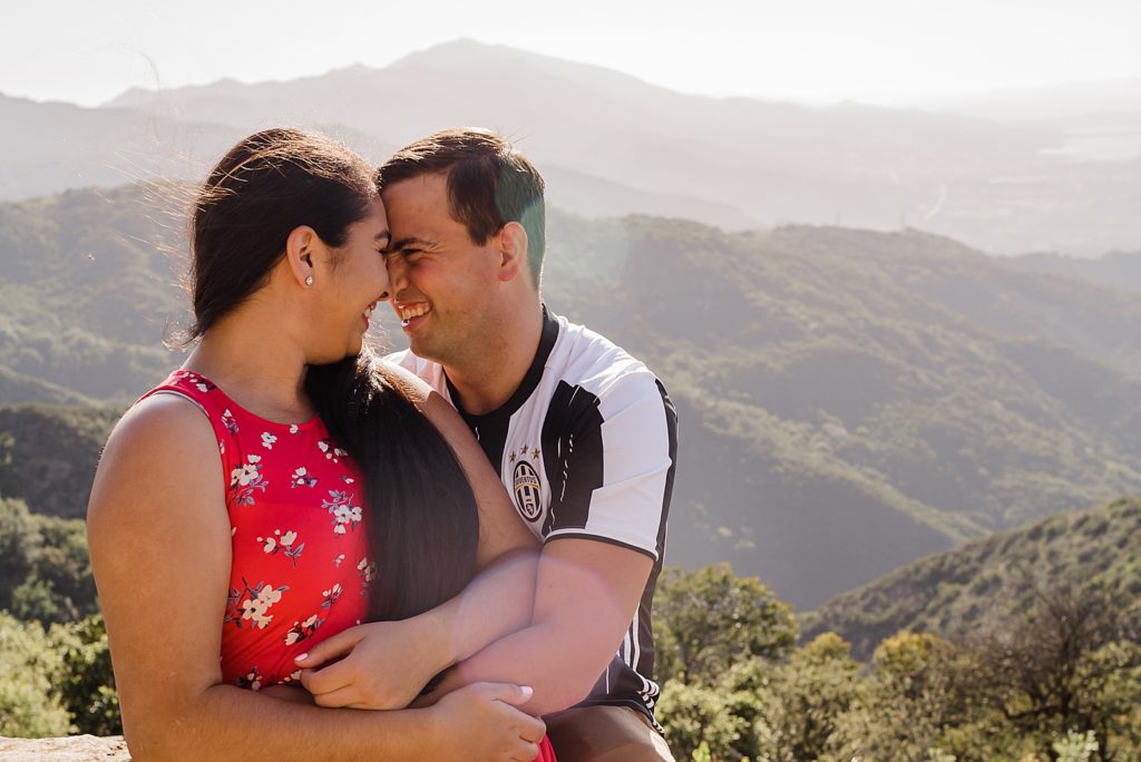 Couple nuzzling their noses with the mountains behind them Santa Barbara Proposal Photography captured by Oregon Engagement Photographer Simply Wandering Photography 