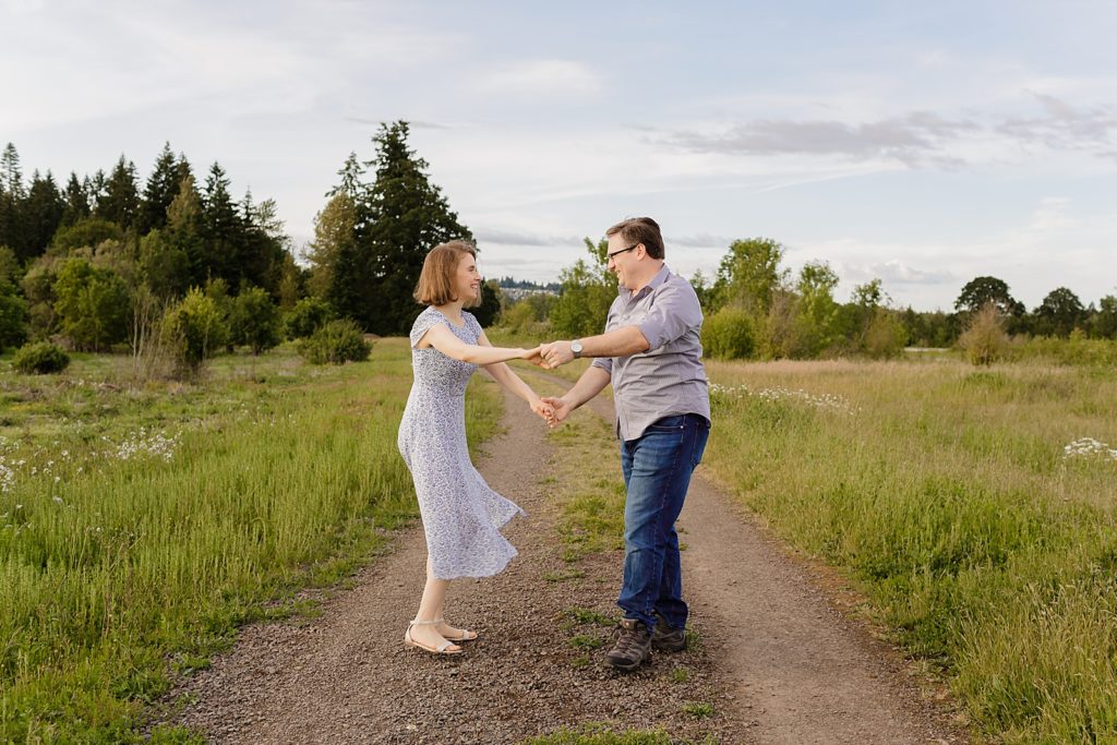 Couple holding hands on dirt trail path