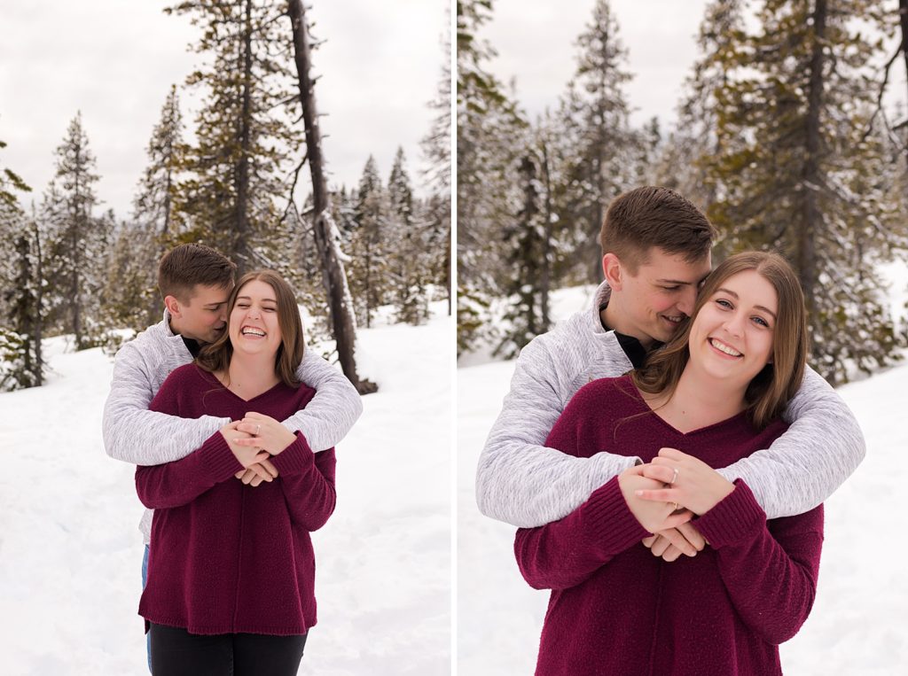 Man nuzzling woman from behind in snowy forest 