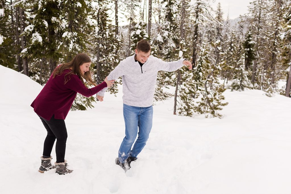 Couple jumping and playing in the snow