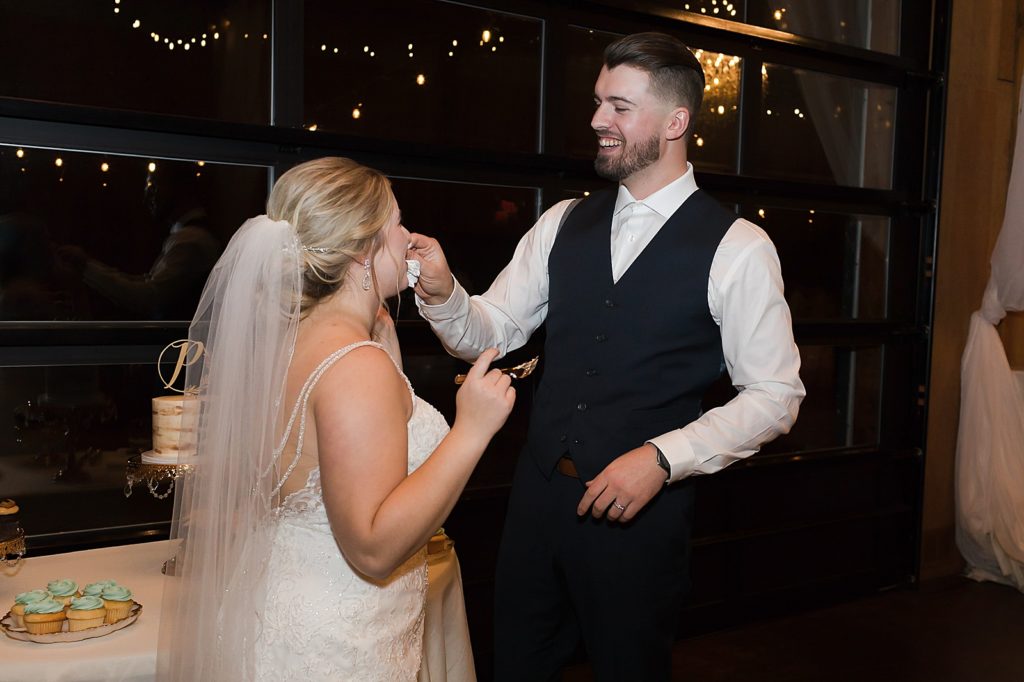 Bride and Groom exchanging cake bites after cake cutting