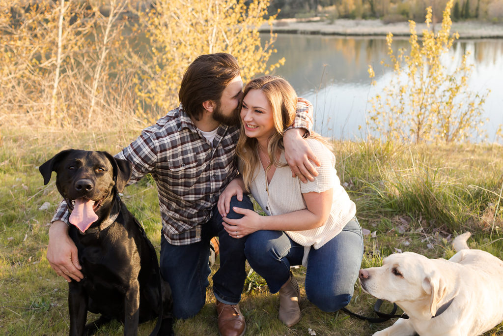 couple kissing with their two labs during columbia river gorge engagement