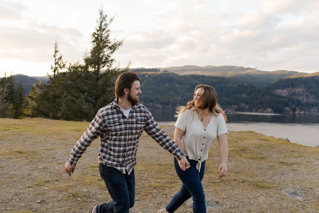 couple running hand in hand during oregon engagement session