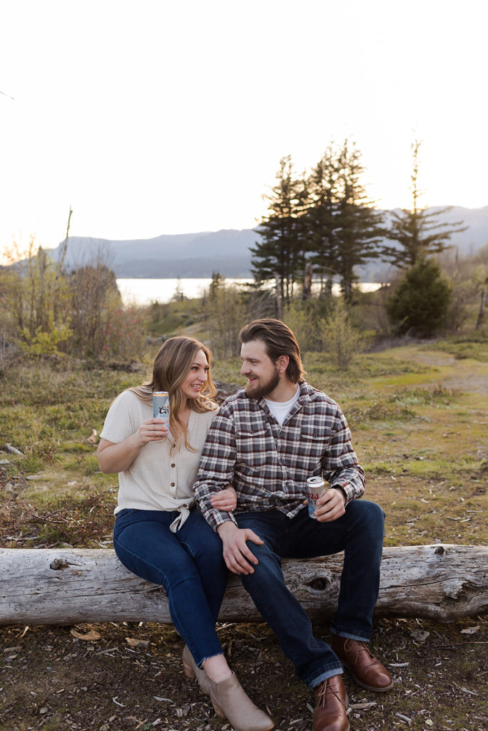 couple with beers during engagement session