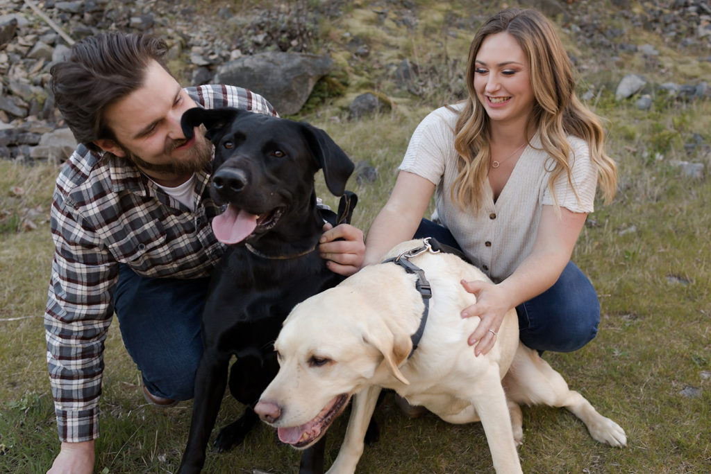 couple kissing their two labs during columbia river gorge engagement
