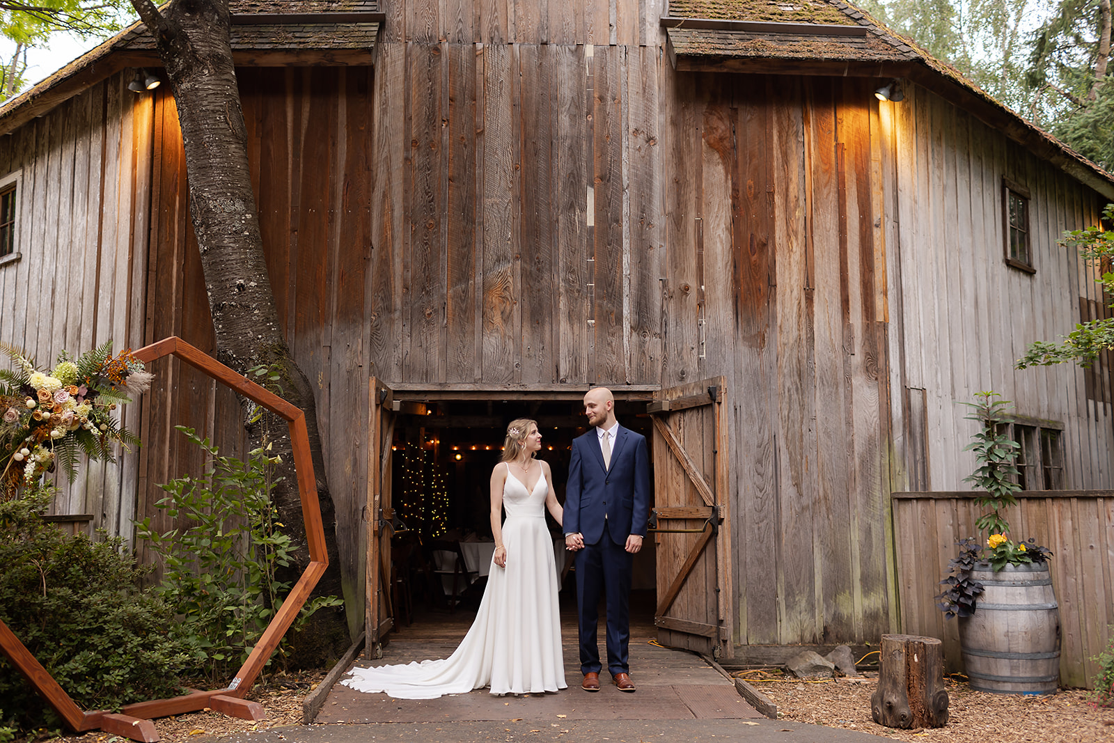 bride and groom in front of barn at Mcmenamins Cornelius Pass Roadhouse Wedding