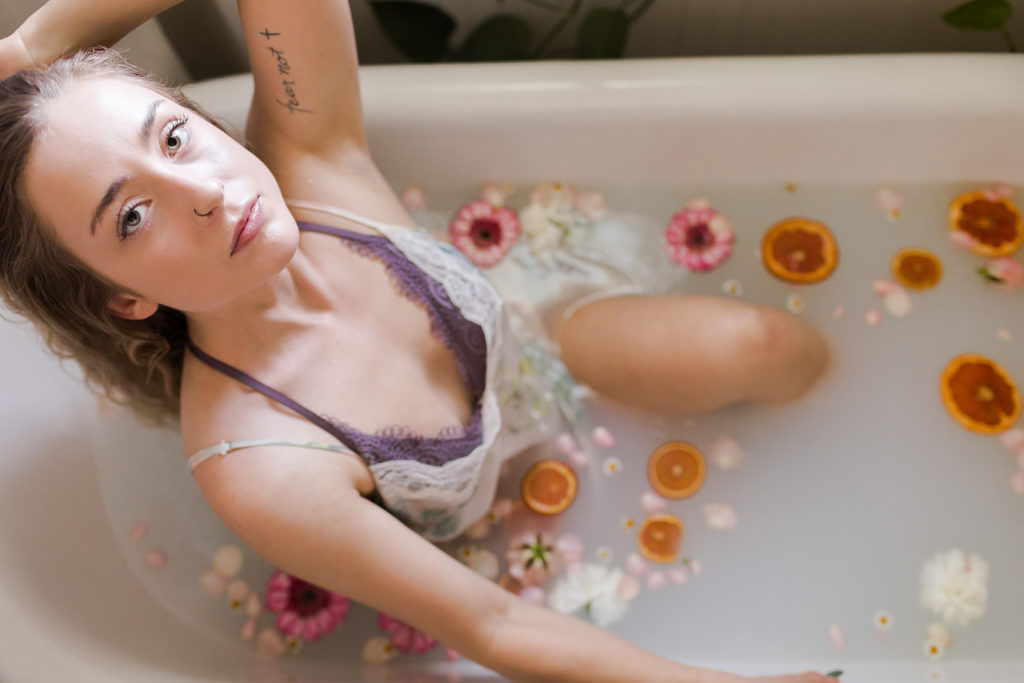 girl in floral gown in bathtub