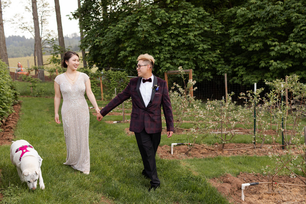 bride and groom walking through vineyard during Romantic Backyard Newberg Wedding Photography