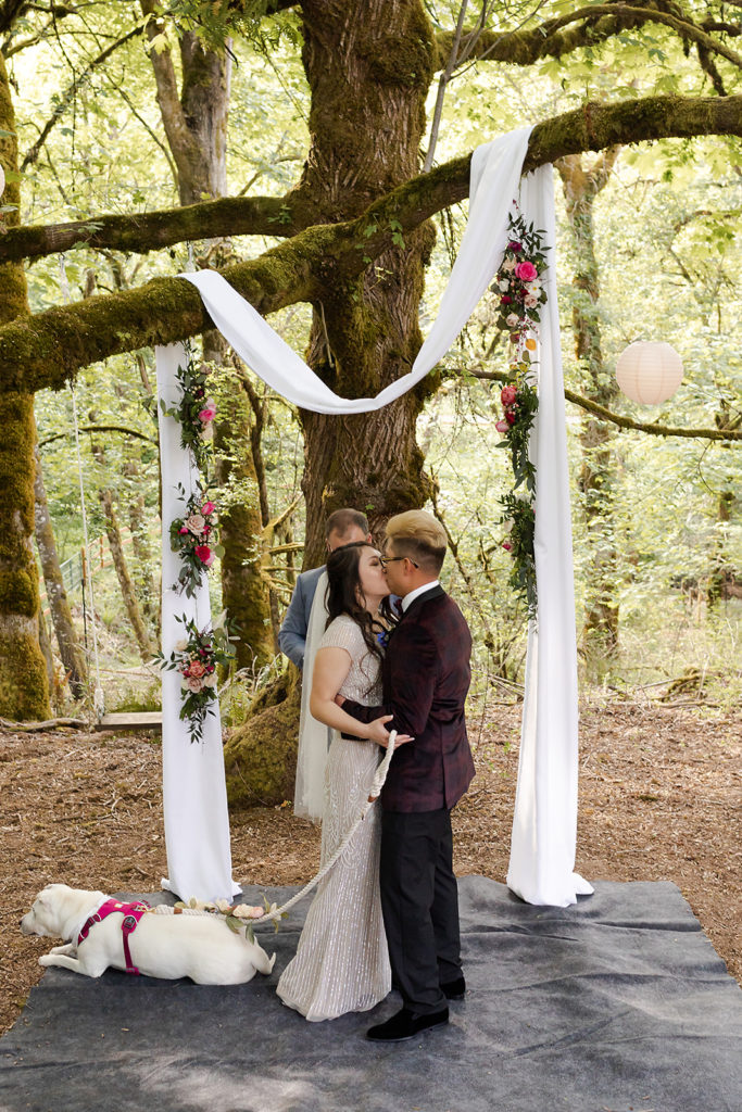 bride and groom sharing first kiss Romantic Backyard Newberg Wedding Photography