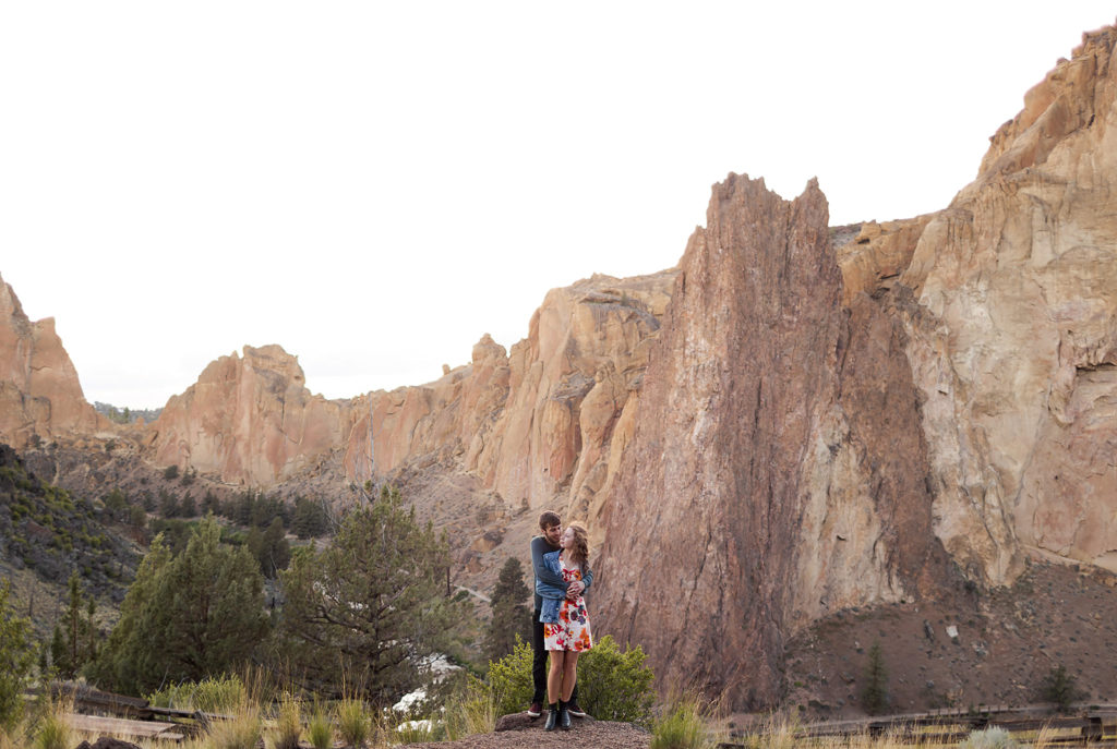 couple standing with smith rock in the background