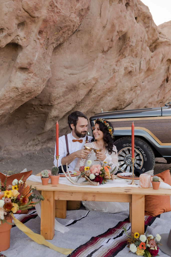 bride and groom at styled table during elopement at vasquez rocks
